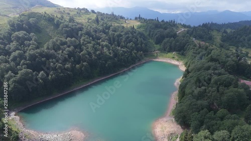  Aerial view green Lake on in Goderdzi Pass Georgia. Alpine Green Lake  in Khulo supporting mountain with forest. Mountain tourism. Freshwater ecology, seasonal travel. 