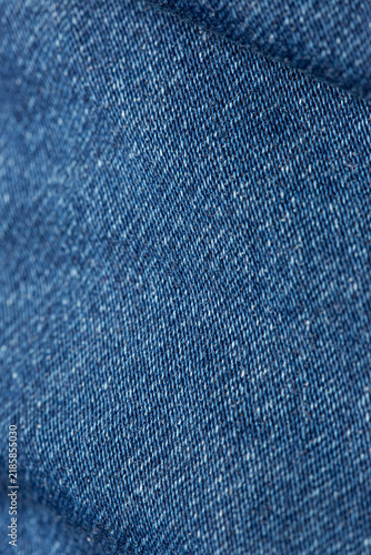 Macro close-up of blue denim fabric showing its detailed woven texture and natural textile pattern.