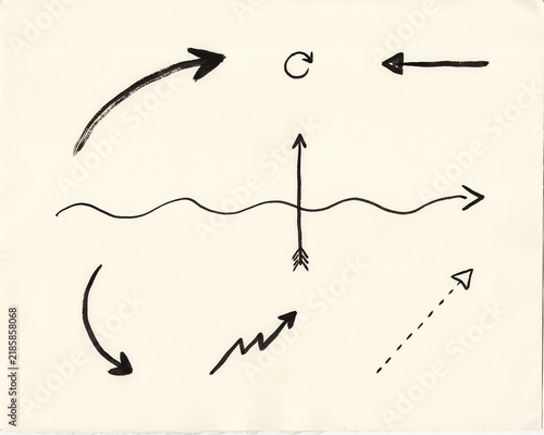 Hand drawn arrow symbols and direction indicators on textured paper surface