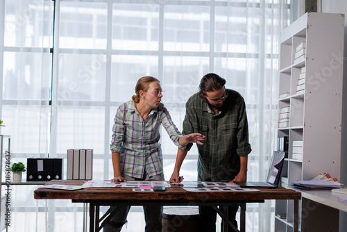 Obraz na plátně Creative professional team collaborating on design project, reviewing color pale