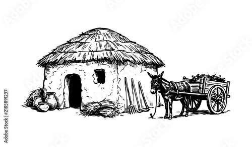 Foto Rustic thatched roof hut with pitchforks clay pots and donkey pulling loaded woo
