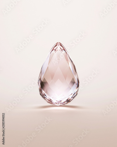 Crystal gemstone on beige background. Rose gold sparkling jewel isolated studio shot. Luxury jewelry concept