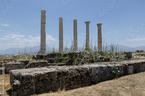 Ancient Laodicea ruins in Turkey with Roman columns, historic stone road, scenic mountains, blue sky, and archaeological heritage site landscape
