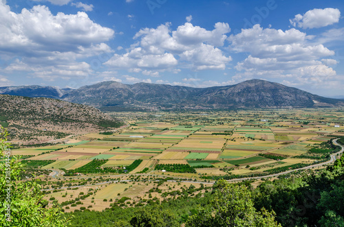 Turkey agricultural landscape with colorful fields, rural village, mountain valley, scenic countryside and dramatic cloudy blue sky