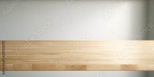 Smooth, light wood surface with subtle light casting shadows on a plain wall