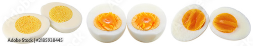 Several halves of hard-boiled eggs with yellow yolks and white shells, isolated on a transparent background.