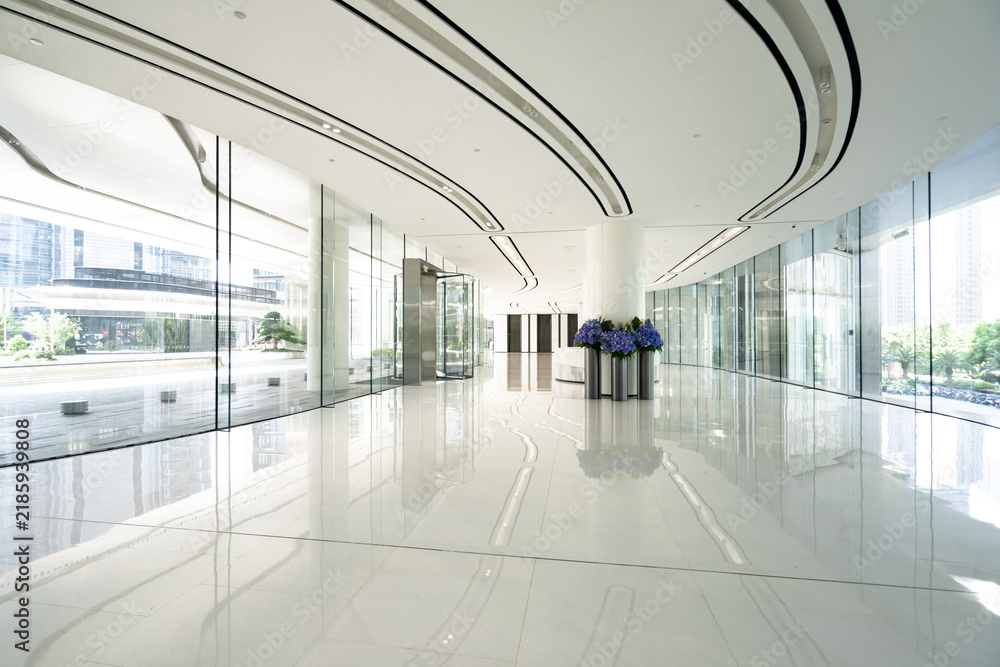 Obraz premium modern office lobby with white marble floor and glass walls