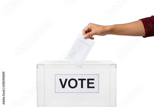 Hand putting vote into ballot box.