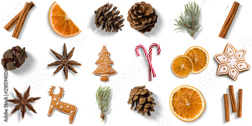 Christmas holiday ingredients and decorations: cinnamon sticks, dried oranges, pine cones, star anise, gingerbread cookies, and pine sprigs on a transparent background