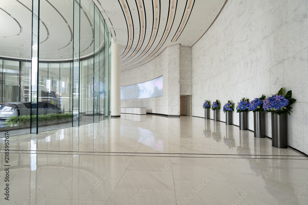 Obraz premium Modern business hall with curved glass walls and flower decorations