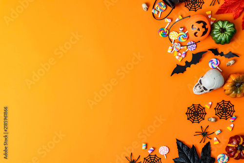 Halloween trick or treat candies and decorations flat lay