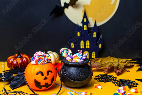 Halloween pumpkins and cauldron filled with colorful candies