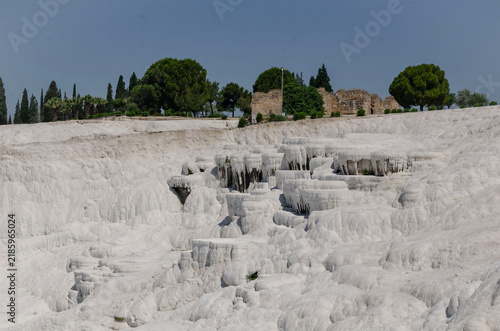 Pamukkale Turkey travertine terraces white mineral formations thermal springs ancient landscape blue sky natural wonder tourism destination geology calcium pools