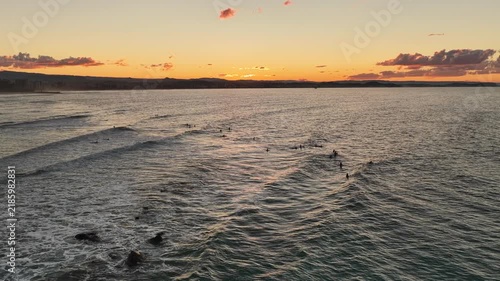 Sunset surfers at Snapper Rocks with the Surfers Paradise skyline beyond, aerial drone view, Gold Coast, Queensland Australia