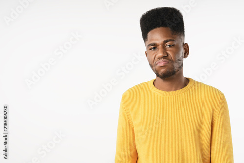 Canvastavla Portrait of angry African man standing isolated over white background, furious y