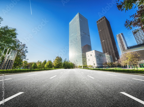Captivating Urban Skyline Featuring a Serene Road and Dazzling Glass Buildings