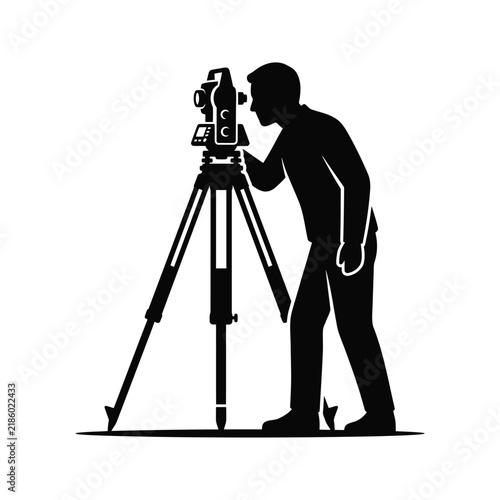Surveyor silhouette using a total station on a tripod in the field with surveyor