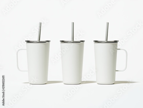 Three matte white tumblers with handles and gray straws stand upright