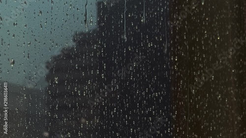 Close Up of Rain Drops on Window With Blurred City Background