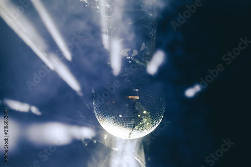 Obraz na plátne Sparkling disco ball reflecting bright lights in a dark nightclub or party venue with dynamic motion blur effect