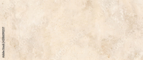 Beige travertine stone texture with natural mottled surface pattern creating a warm rustic background for interior and architecture design