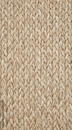Close-up of a natural sisal rug featuring a tight chunky weave and organic fiber texture