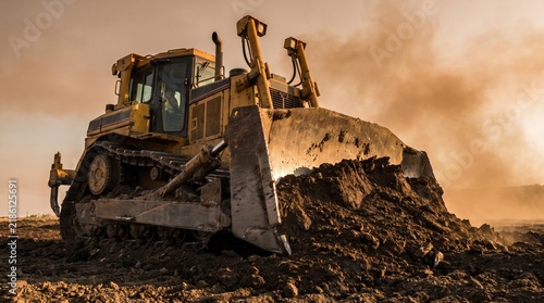 Heavy Bulldozer Moving Earth on Construction Site with Powerful Earthmoving Blade