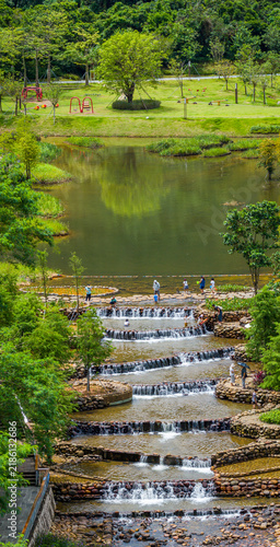 Aerial View of Happy joyful boy and girl play in water at Toupi Park, Shenzhen, Guangdong Province, China.