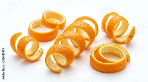 Fresh orange peel spirals isolated on white background.