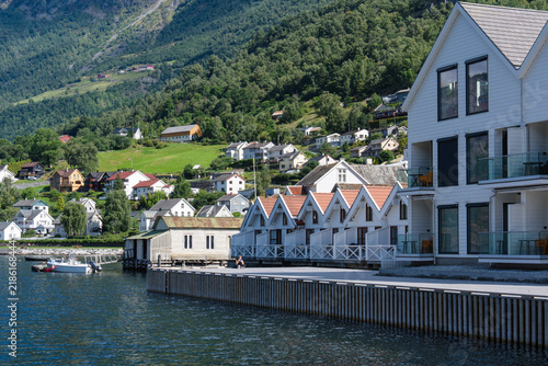 Picturesque Norwegian fjord village with waterfront houses nestled against green mountains