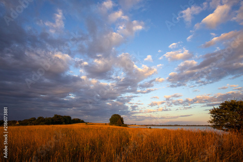 Dramatic morning light over the rolling coastal hills and fields at Stavns Fjord on Samsø island, Denmark