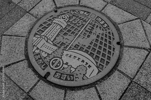 Photography Decorative Japanese manhole cover with local townscape design in monochrome