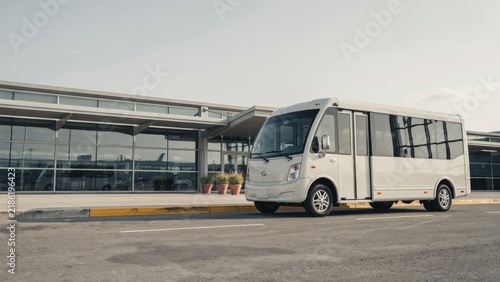 Shuttle Bus Parked in Front of Modern Airport Terminal Building, Transportation Concept