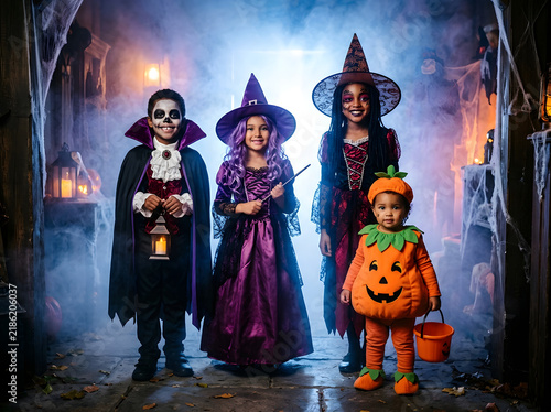 Group of diverse children in Halloween costumes trick or treating in a spooky house