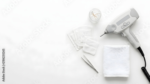 Cosmetology equipment flat lay on white table. Medical aesthetic tools and device for skincare procedures. Copy space for text