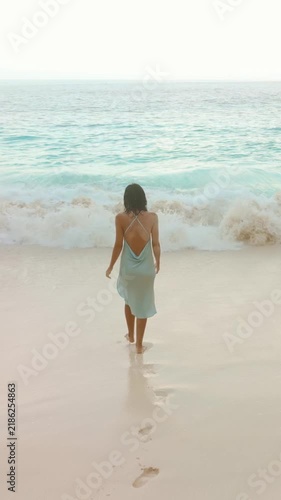 Woman in Blue Dress Walking Toward Ocean