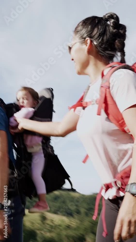 Multiethnic family with a baby hiking in the mountains