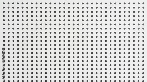 Minimalist white pegboard with uniform black holes - background texture