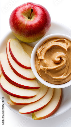 healthy apple slices with peanut butter dip isolated on white background