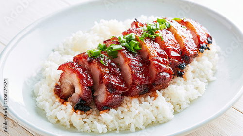 char siu roasted pork slices over rice isolated background