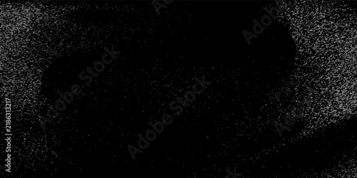 Flying dust particles on a black background