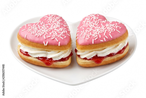 Heart Shaped Pink Glazed Donuts with Cream and Jam Filling on a White Plate