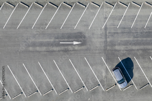 Top view on parking lots with one car