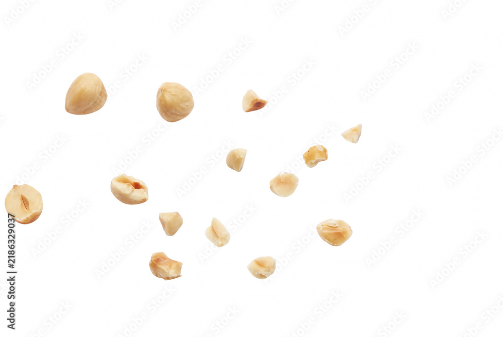 Obraz premium Falling Roasted Hazelnut Pieces and Whole Nuts Isolated on Dark Space