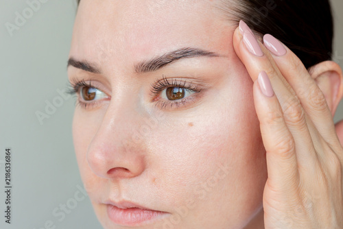 Принти на полотні Close up of a young woman pulling her temple skin up for blepharoplasty and eye lifting effect