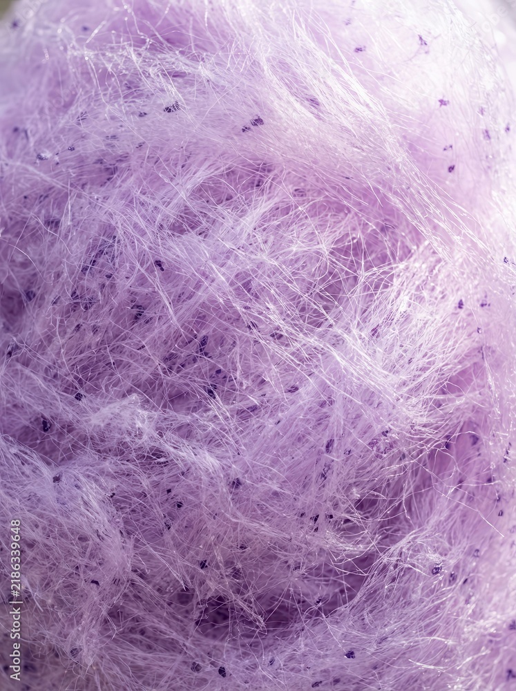 Fototapeta premium Macro Close-up of Fluffy Purple Cotton Candy Texture with Sugary Fibers and Sweet Lavender Candy Floss Background