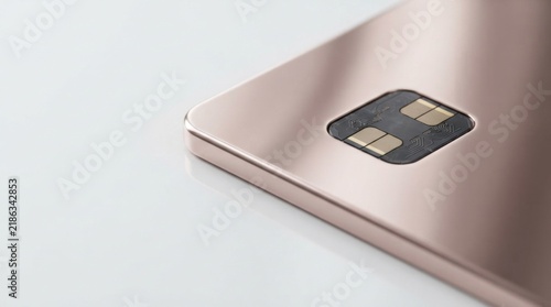 Close up of a rose gold credit card with a secure electronic chip