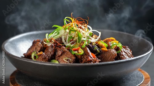 Sizzling beef skillet dish served in a modern shallow bowl steam effect rich textures light background sharp focus