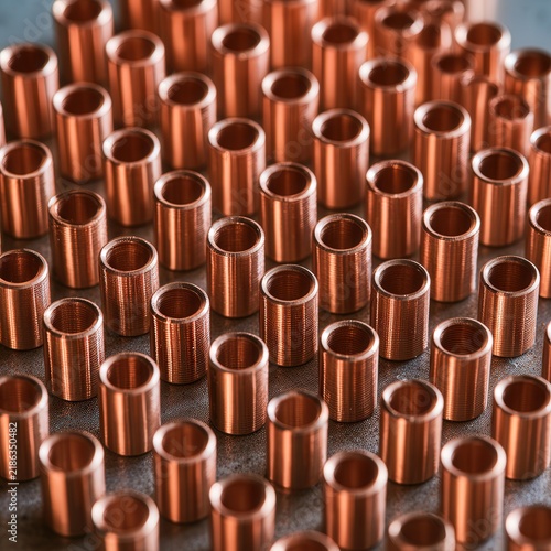 Many copper bushings arranged in a pattern
