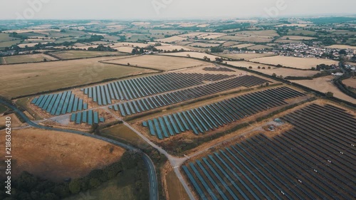 Aerial view of rows of solar panels in fields